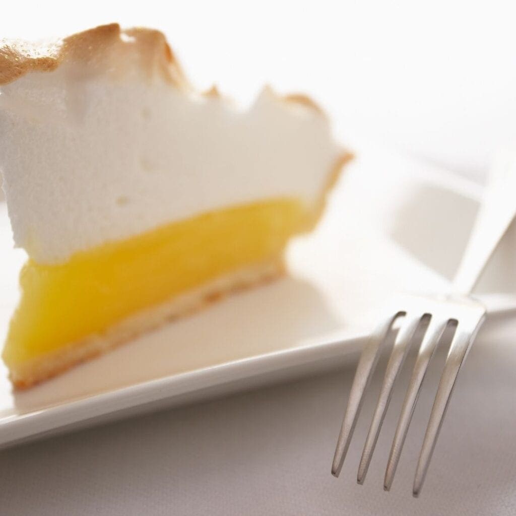 Slice of Lemon Meringue Pie on a Plate with a Fork