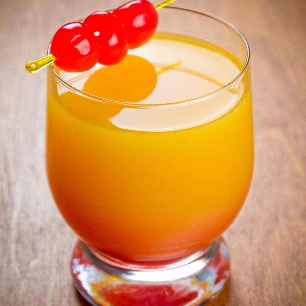 Sunrise Drink Garnished with Maraschino Cherries