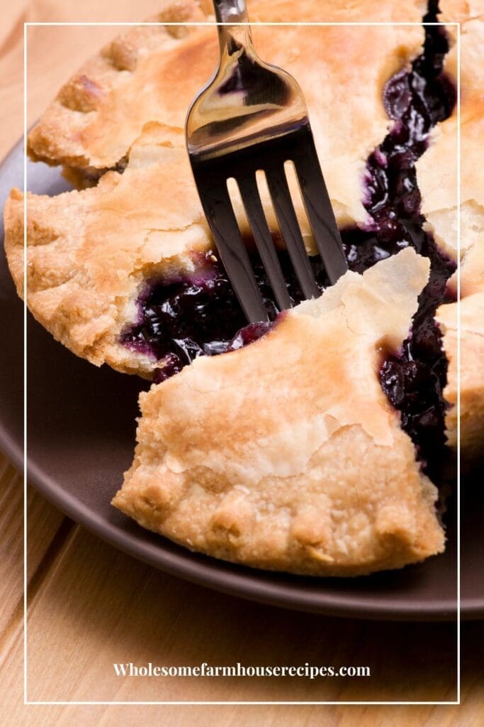 Digging into a whole blueberry pie