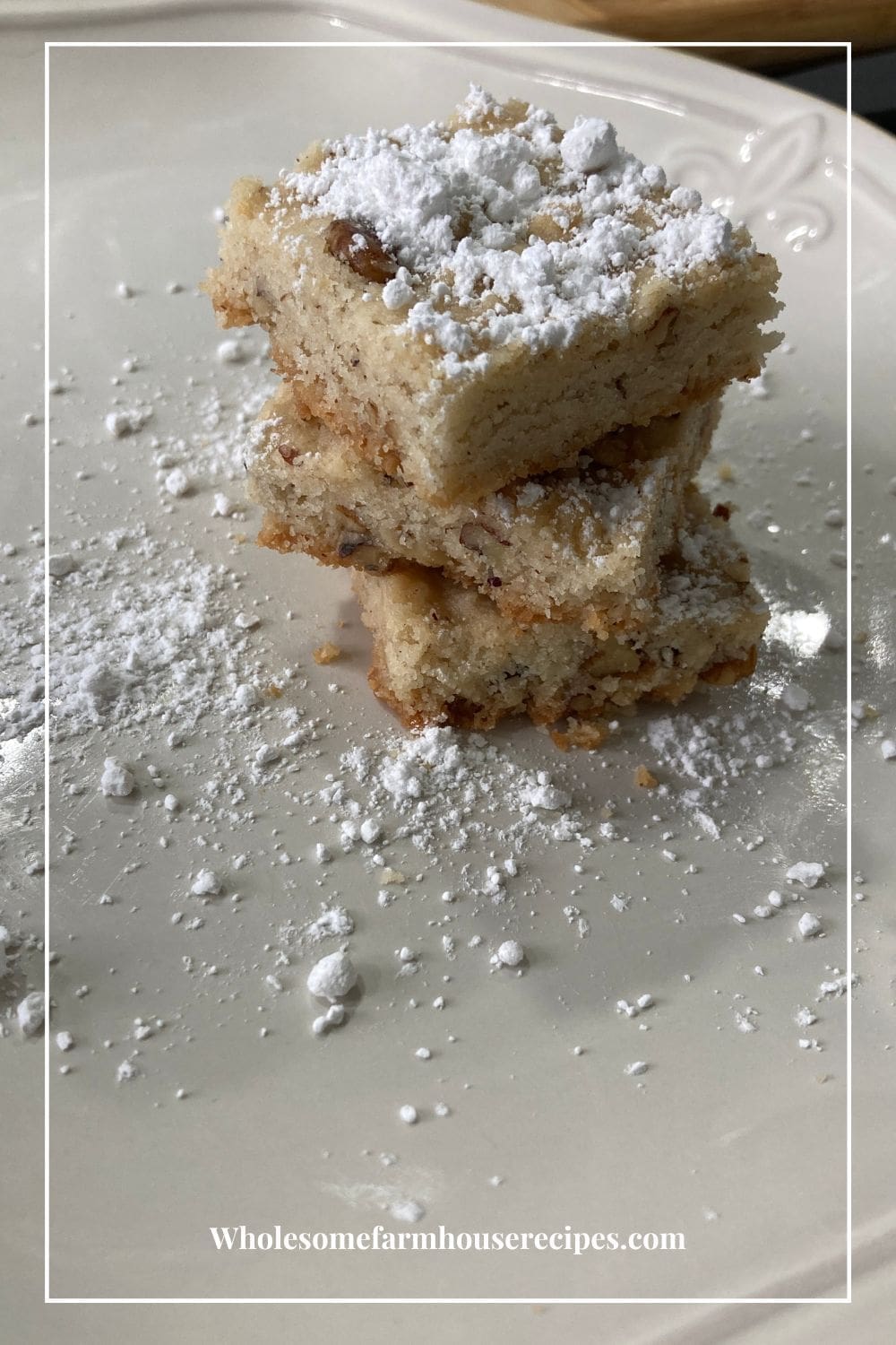 Pecan Bar Cookies Stacked and Topped with Powdered Sugar