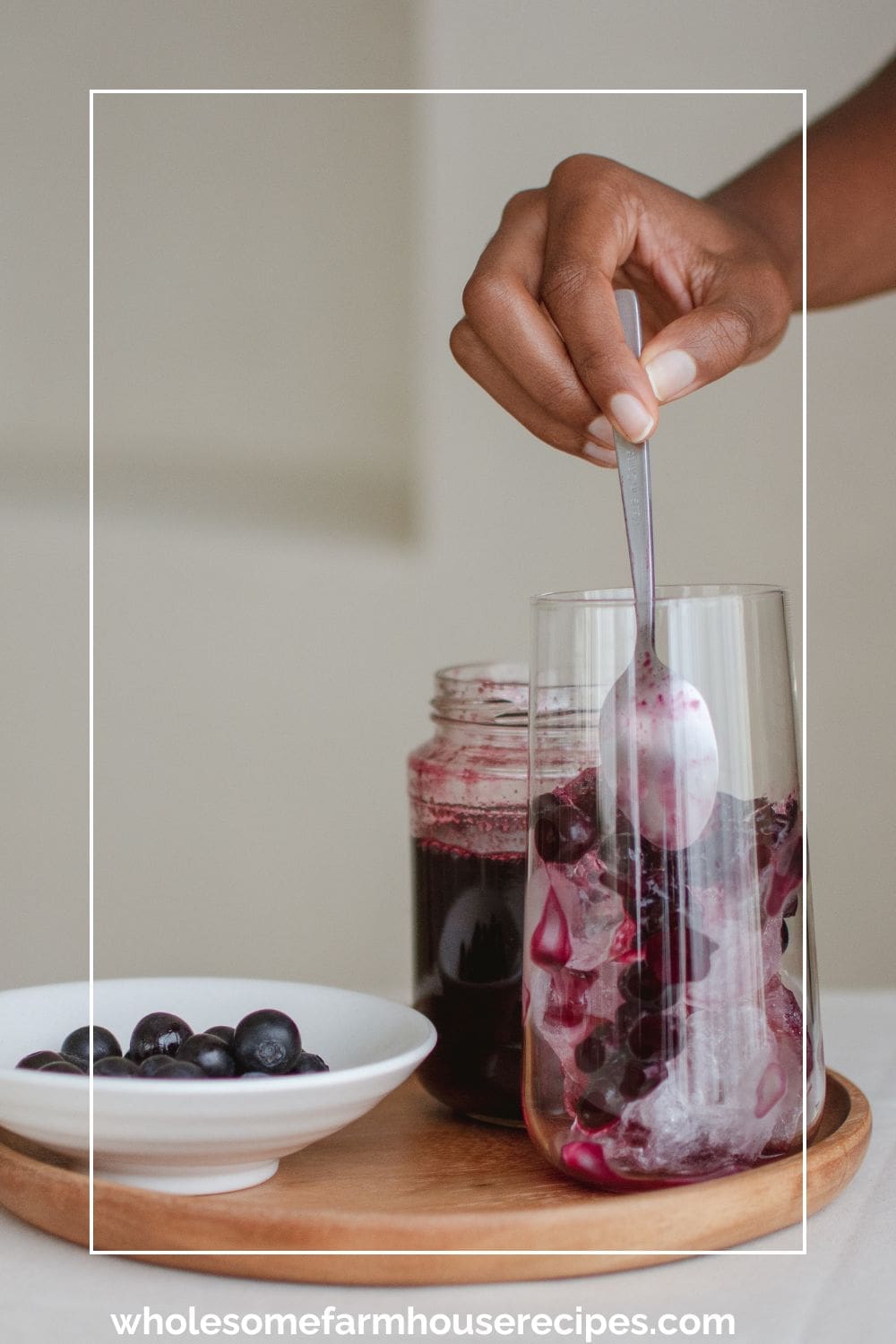 Adding Fresh Blueberries to Glass of Ice