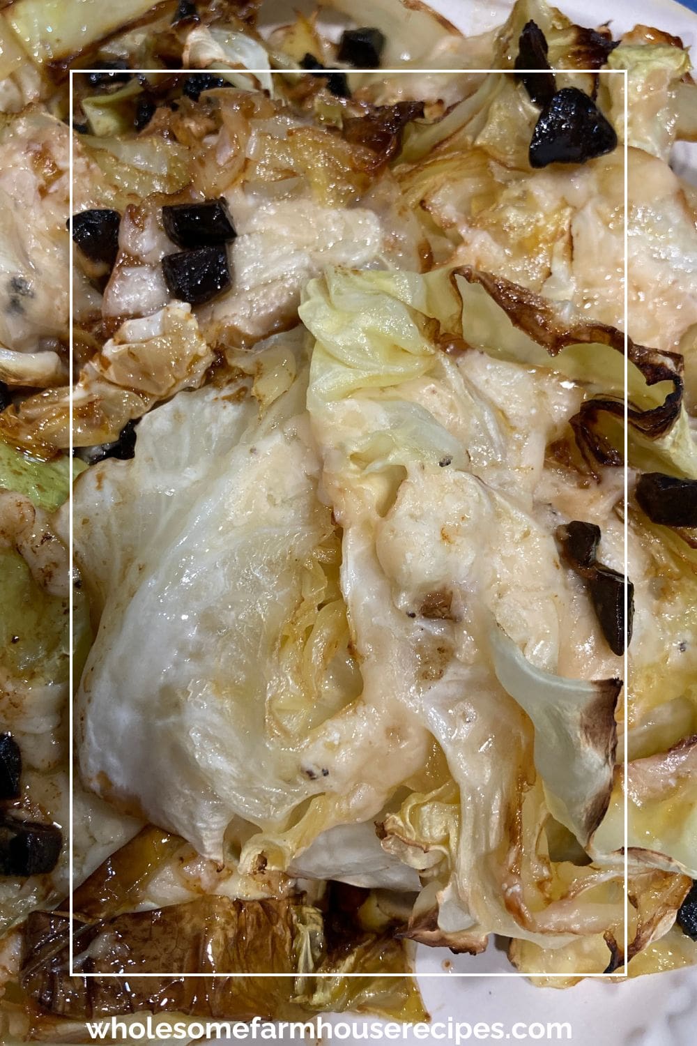 Cooked cabbage slices with cheese and black garlic