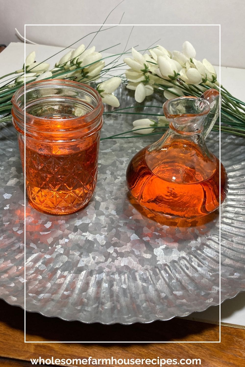 Two jars of simple syrup infused with peaches